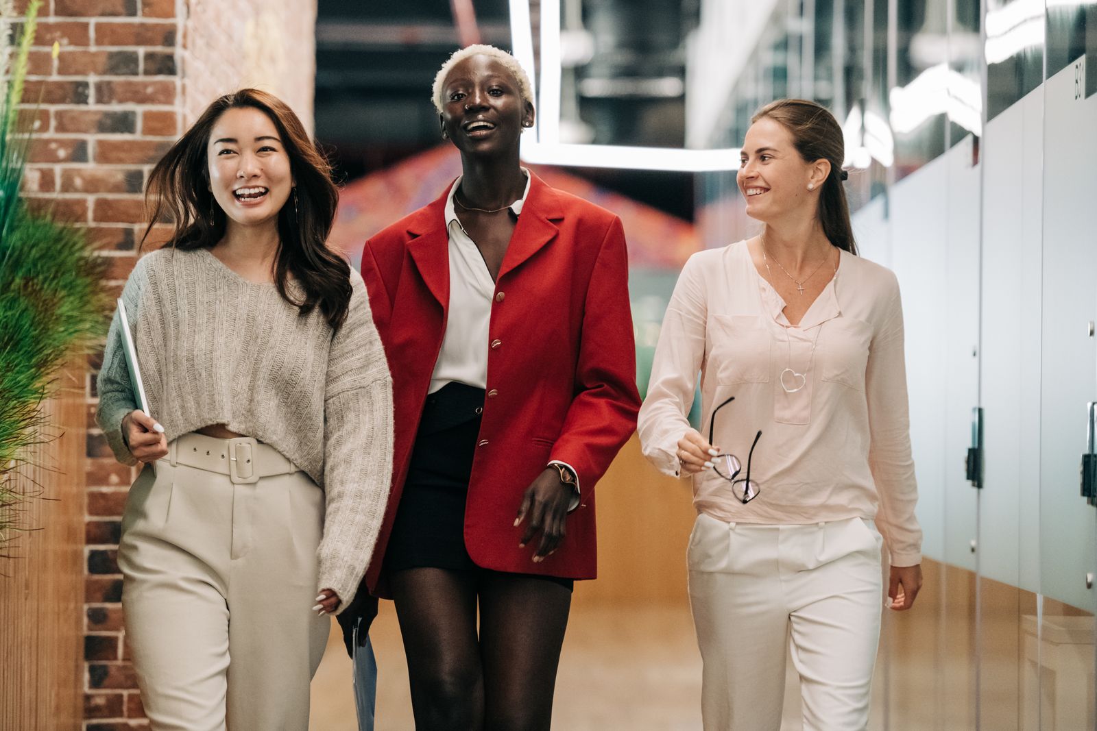 A diverse group of smiling employees in a contemporary office, representing live company headcount.