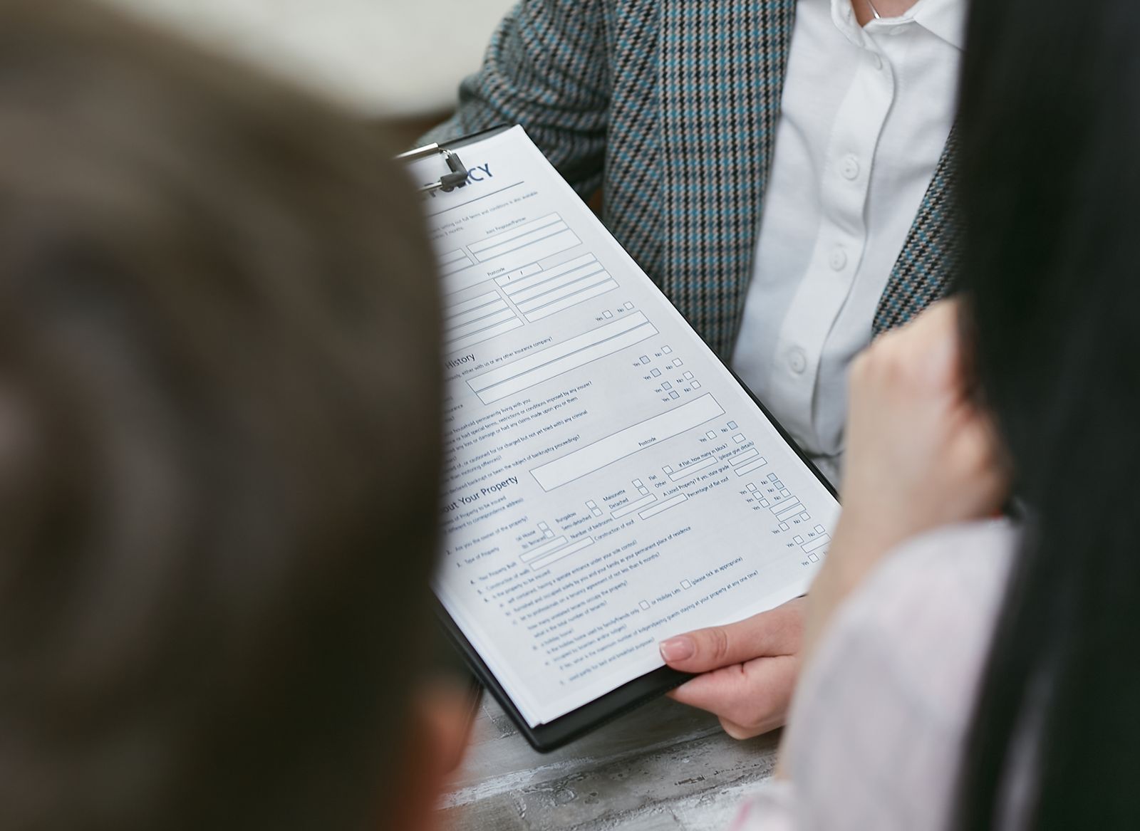 Two professionals discussing a legal compliance document
