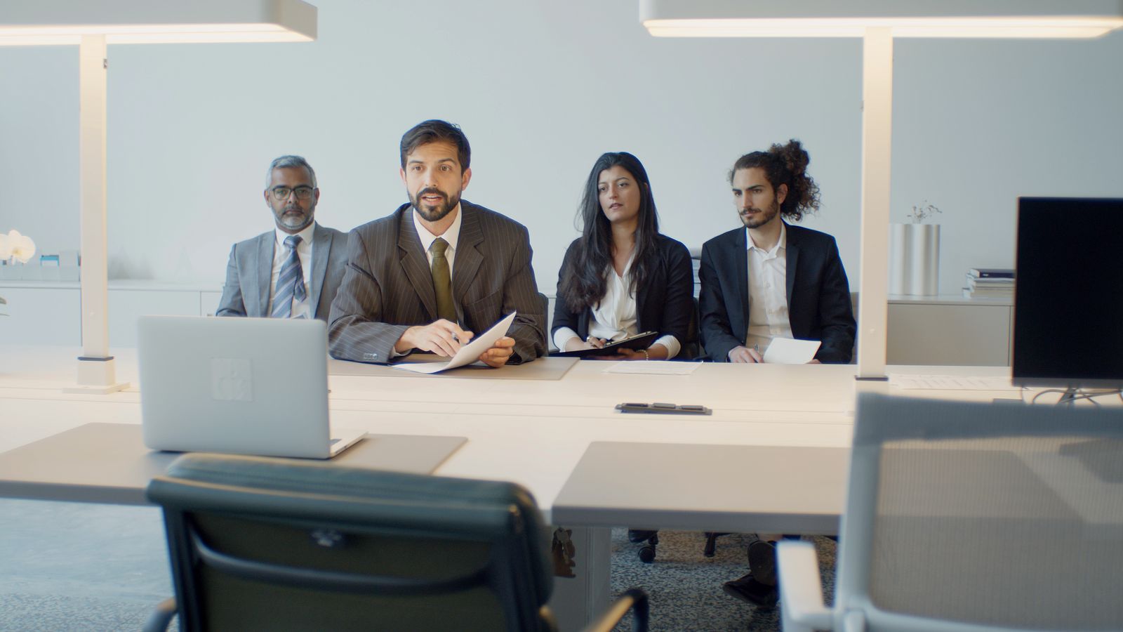 A diverse hiring panel coordinating over a video conference